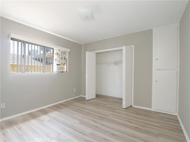 2302 S Gaffey St Unit 1, San Pedro, CA 90731 - unfurnished bedroom featuring light wood-style floors, a closet, and baseboards