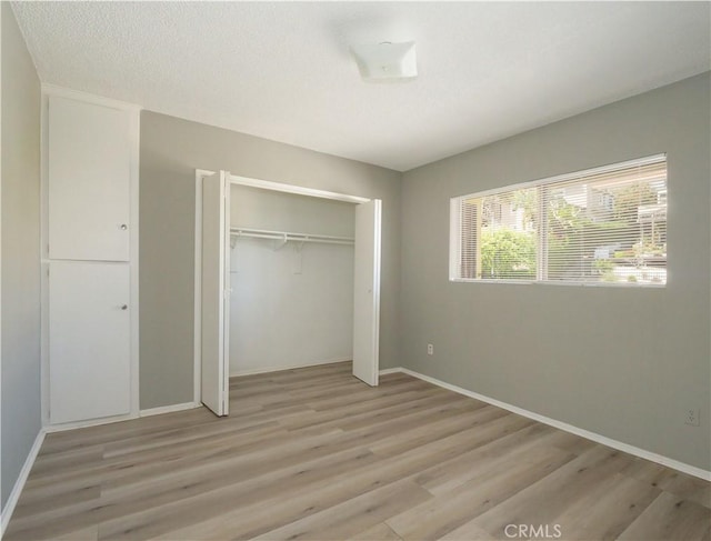 2302 S Gaffey St Unit 1, San Pedro, CA 90731 - unfurnished bedroom with light wood finished floors, a closet, and baseboards