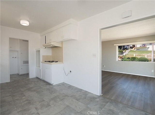 2302 S Gaffey St Unit 1, San Pedro, CA 90731 - kitchen with under cabinet range hood, white cabinets, white gas cooktop, and light countertops
