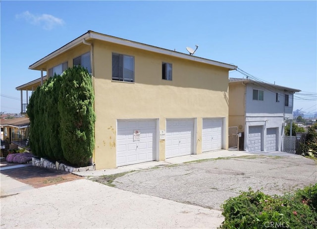 2302 S Gaffey St Unit 1, San Pedro, CA 90731 - view of property exterior featuring an attached garage, stucco siding, and driveway
