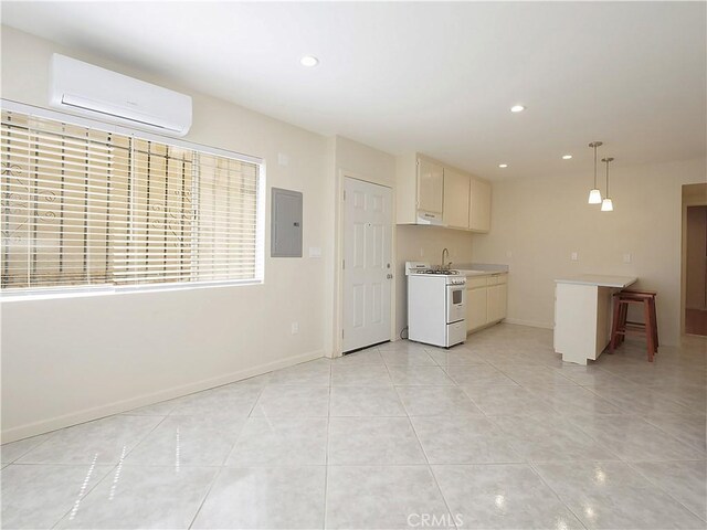 2302 S Gaffey St Unit 1, San Pedro, CA 90731 - kitchen featuring white gas range oven, a wall mounted AC, electric panel, light countertops, and recessed lighting