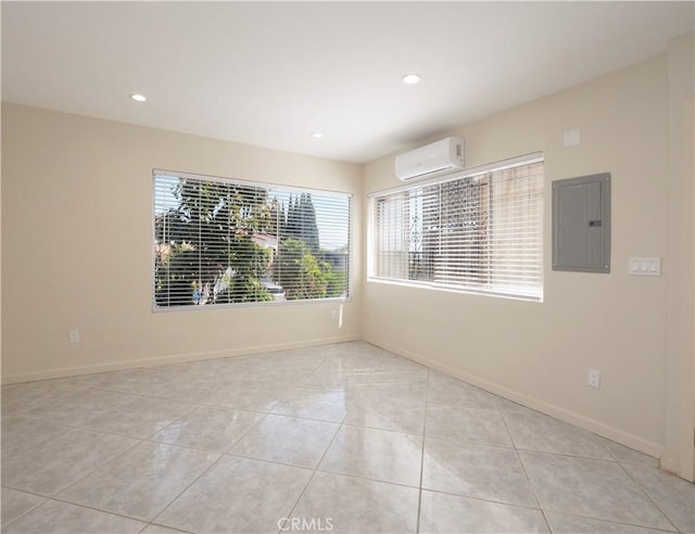 2302 S Gaffey St Unit 1, San Pedro, CA 90731 - empty room with electric panel, a wall unit AC, light tile patterned floors, baseboards, and recessed lighting