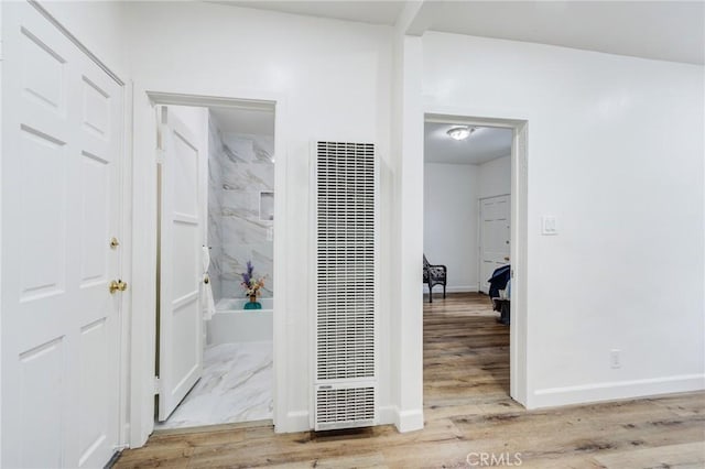 1449 W 45th St, Los Angeles, CA 90062 - hall featuring a heating unit, wood finished floors, and baseboards
