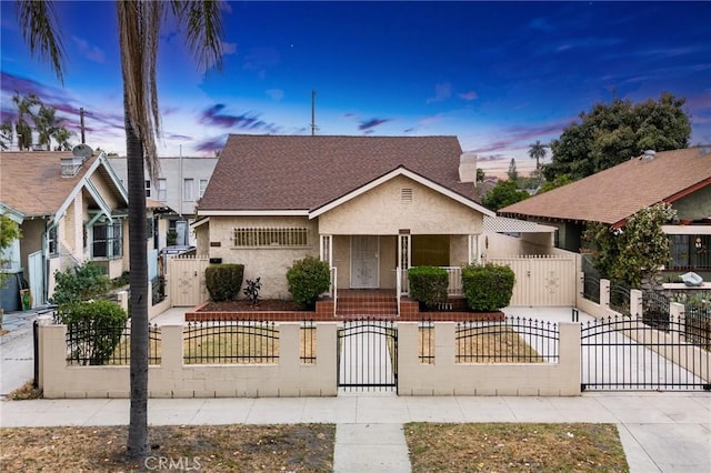 1449 W 45th St, Los Angeles, CA 90062 - view of front of house featuring a gate, a fenced front yard, a porch, concrete driveway, and stucco siding
