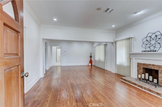1449 W 45th St, Los Angeles, CA 90062 - unfurnished living room with crown molding, wood finished floors, a fireplace with raised hearth, and baseboards