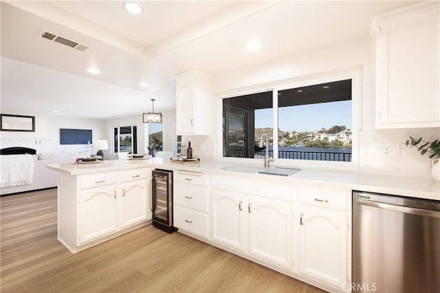 29284 Big Range Rd, Canyon Lake, CA 92587 - kitchen featuring stainless steel dishwasher, a peninsula, a sink, beverage cooler, and open floor plan