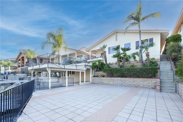 29284 Big Range Rd, Canyon Lake, CA 92587 - view of front of home with a patio, stucco siding, and a balcony