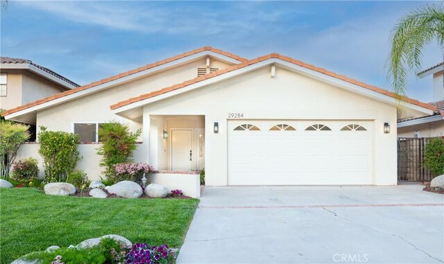 29284 Big Range Rd, Canyon Lake, CA 92587 - view of front of house featuring concrete driveway, a garage, and stucco siding