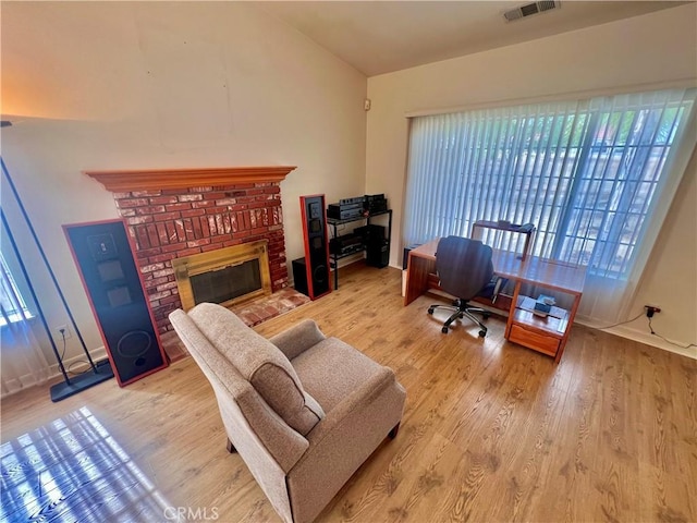 18725 Dallas Ave, Riverside, CA 92508 - home office with a brick fireplace, plenty of natural light, visible vents, and wood finished floors
