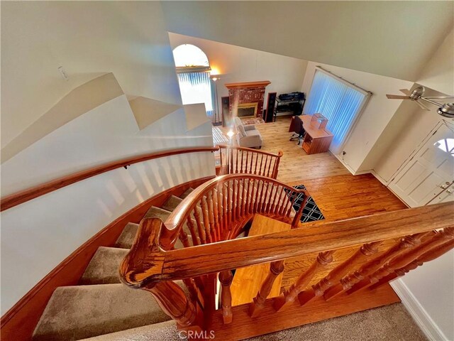 18725 Dallas Ave, Riverside, CA 92508 - stairway with high vaulted ceiling, ceiling fan, and a glass covered fireplace