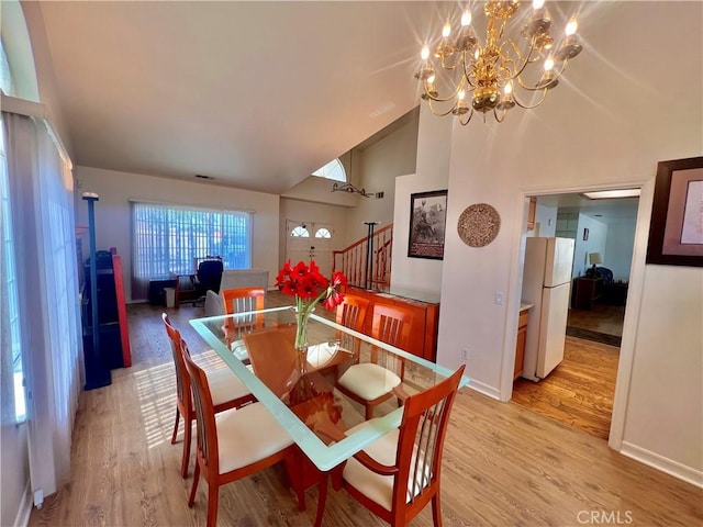 18725 Dallas Ave, Riverside, CA 92508 - dining area with a notable chandelier, baseboards, stairs, high vaulted ceiling, and light wood-style floors