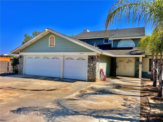 18725 Dallas Ave, Riverside, CA 92508 - traditional home with a garage, a shingled roof, stone siding, and driveway