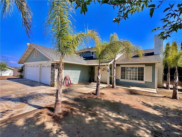 18725 Dallas Ave, Riverside, CA 92508 - view of front of house featuring concrete driveway, an attached garage, and a chimney