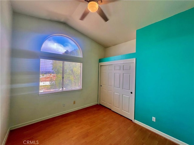 18725 Dallas Ave, Riverside, CA 92508 - unfurnished bedroom with a closet, wood finished floors, vaulted ceiling, a ceiling fan, and baseboards