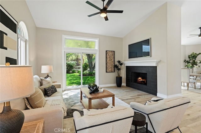44240 La Cruz Dr, Temecula, CA 92590 - living area with high vaulted ceiling, light wood-style flooring, a ceiling fan, baseboards, and a tile fireplace