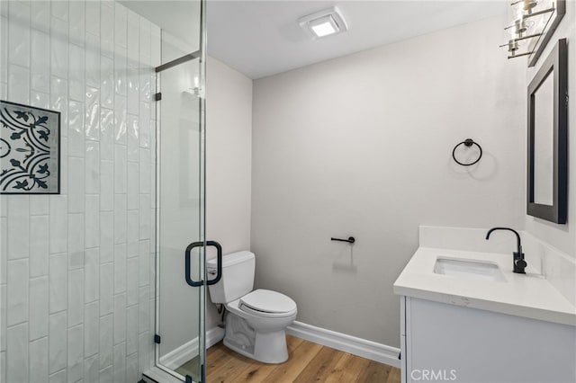 44240 La Cruz Dr, Temecula, CA 92590 - bathroom featuring toilet, wood finished floors, a stall shower, baseboards, and vanity