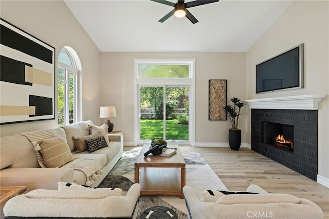 44240 La Cruz Dr, Temecula, CA 92590 - living area featuring vaulted ceiling, ceiling fan, a tiled fireplace, and wood finished floors