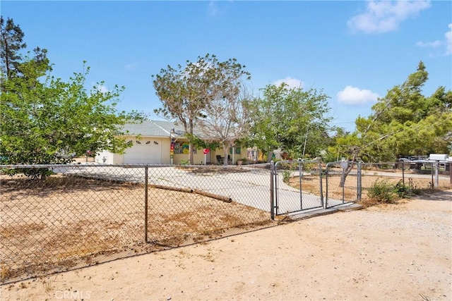 9546 Verdugo Ave, Hesperia, CA 92345 - view of front of house with driveway, a fenced front yard, a garage, and a gate