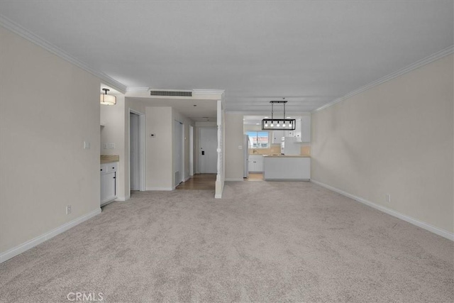 unfurnished living room with visible vents, baseboards, ornamental molding, and light carpet