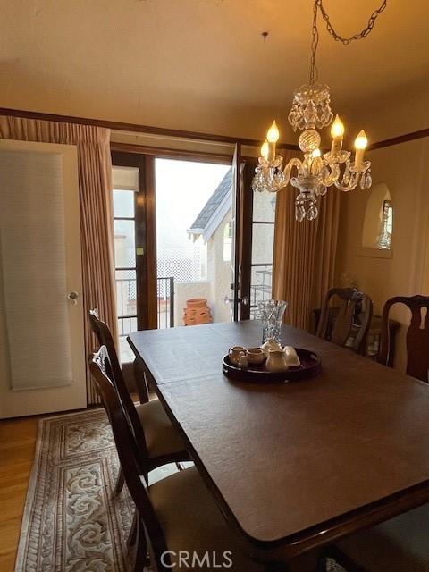 dining room with a chandelier and wood finished floors