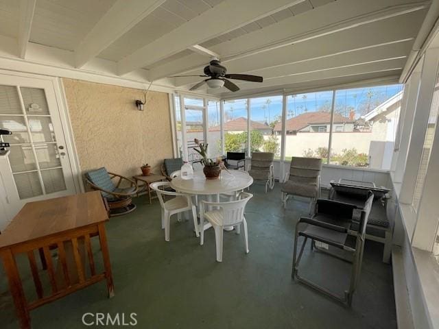 sunroom featuring ceiling fan and beamed ceiling
