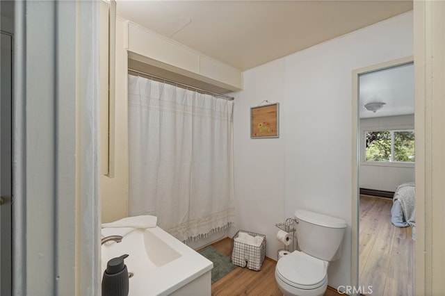 full bath featuring toilet, a shower with curtain, vanity, and wood finished floors