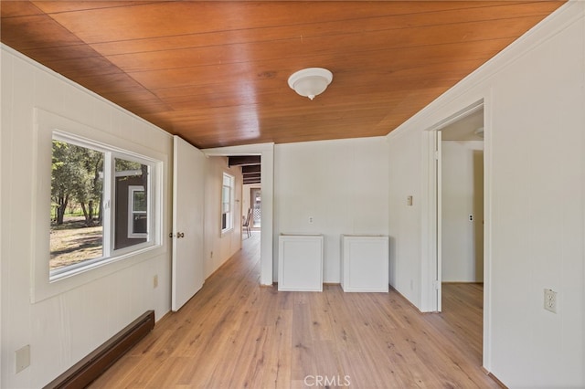 unfurnished room with wooden ceiling, light wood-style flooring, baseboard heating, and ornamental molding