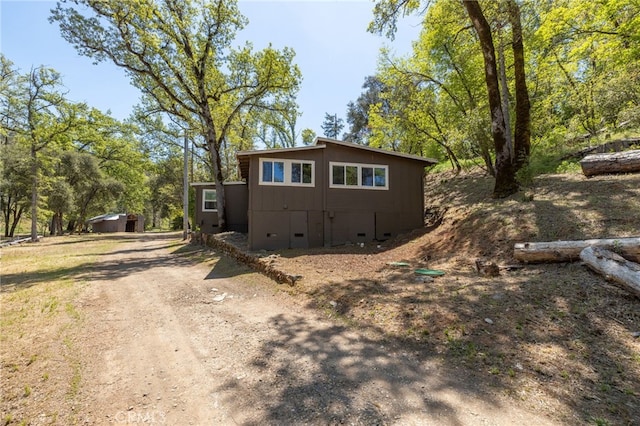 view of front facade featuring driveway and crawl space