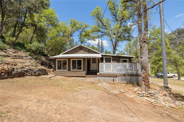 view of front of home featuring a porch and metal roof