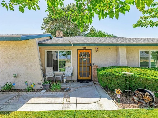 property entrance featuring stucco siding