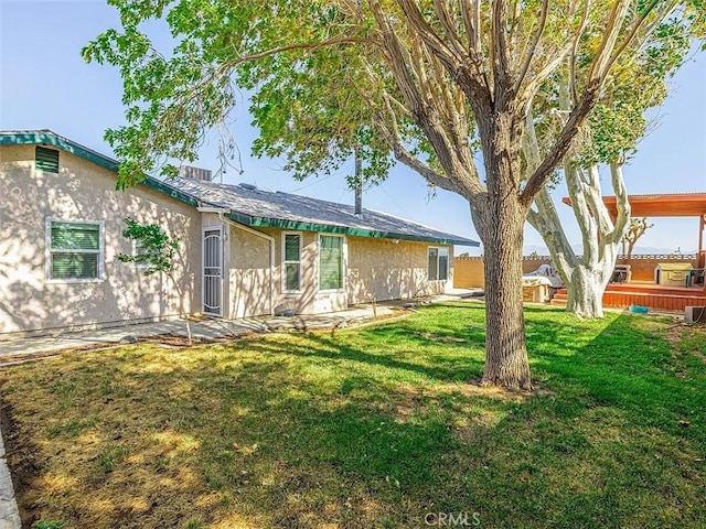 view of front of home with a front lawn and stucco siding