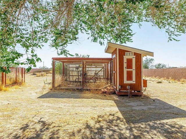 view of poultry coop featuring fence
