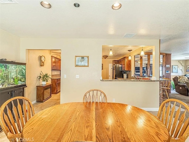 dining room featuring recessed lighting, baseboards, visible vents, and light wood-style floors