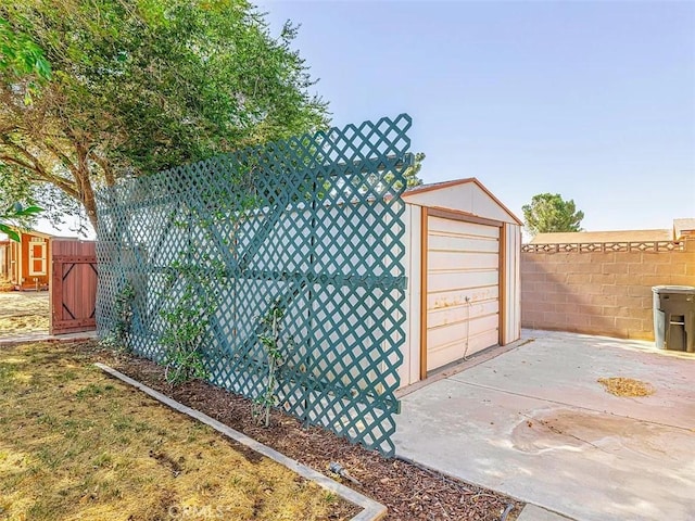 view of shed featuring fence