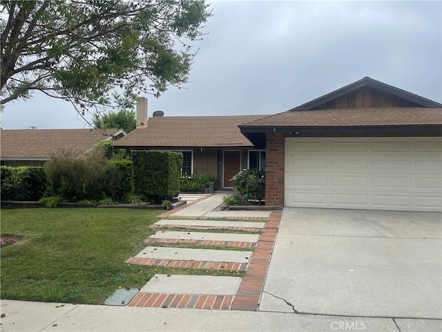 single story home featuring a garage, a chimney, concrete driveway, a front yard, and roof with shingles