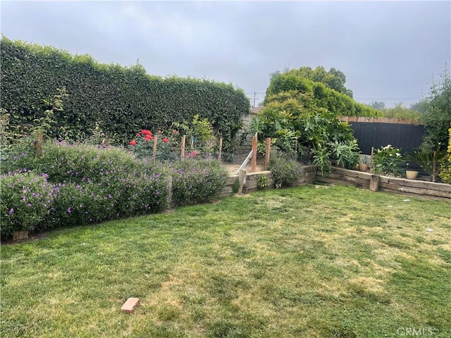 view of yard featuring a garden and fence