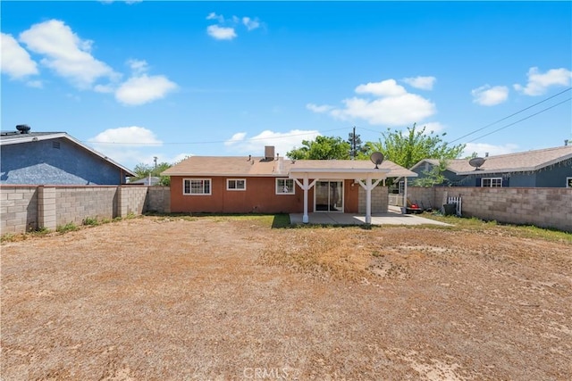 back of house featuring a patio area and a fenced backyard