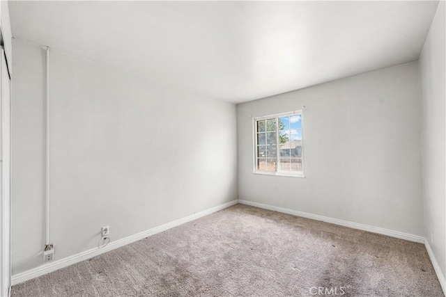 spare room with carpet flooring and baseboards