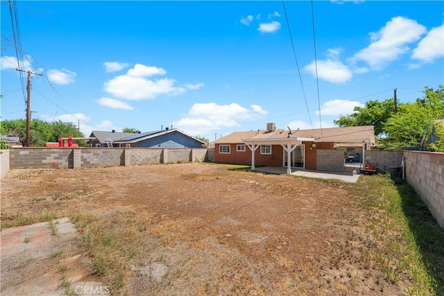 back of house with a patio and a fenced backyard