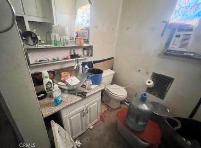 bathroom featuring toilet, cooling unit, and vanity
