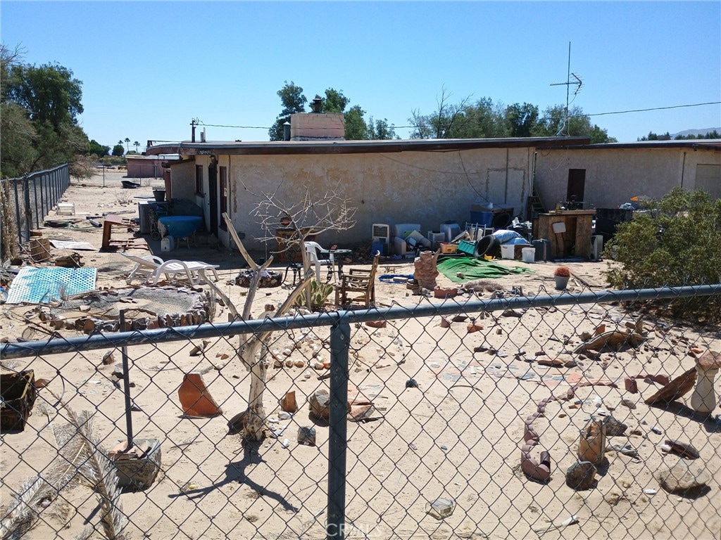 4515 Sierra Way Unit 29, Palms, CA 92277 - view of property exterior with stucco siding and a chimney