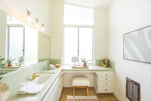 bathroom with vanity, visible vents, and wood finished floors