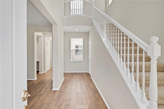 39992 Pasadena Dr, Temecula, CA 92591 - entryway with baseboards, wood finished floors, stairs, and a towering ceiling