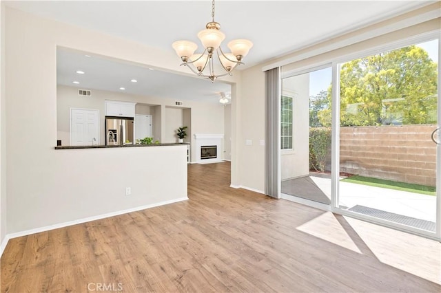 39992 Pasadena Dr, Temecula, CA 92591 - unfurnished dining area featuring a chandelier, light wood-style floors, baseboards, recessed lighting, and a fireplace