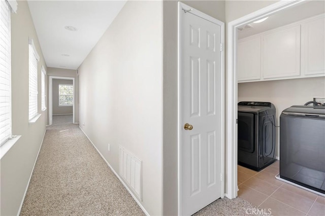 39992 Pasadena Dr, Temecula, CA 92591 - hall featuring washing machine and clothes dryer, baseboards, light colored carpet, and light tile patterned flooring