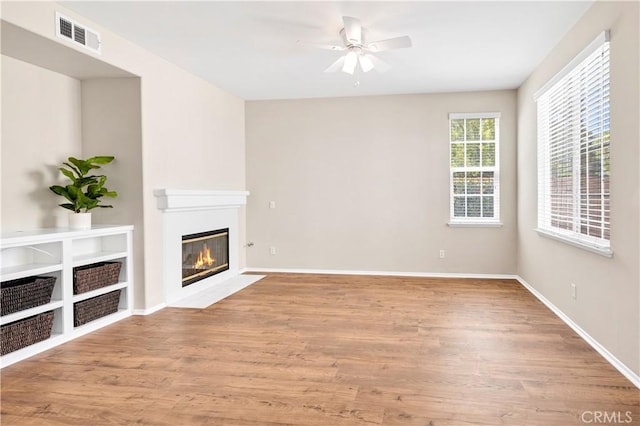 39992 Pasadena Dr, Temecula, CA 92591 - unfurnished living room with ceiling fan, a fireplace with flush hearth, wood finished floors, and baseboards