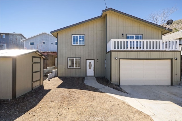 3516 Illinois Trl, Frazier Park, CA 93225 - view of front of property featuring a storage shed, an outdoor structure, a balcony, concrete driveway, and a garage