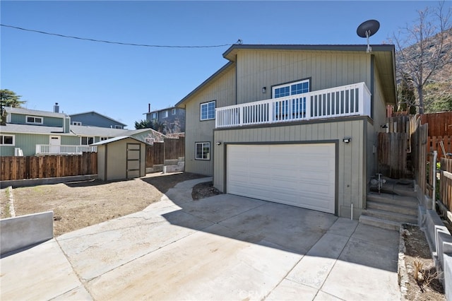 3516 Illinois Trl, Frazier Park, CA 93225 - view of front facade featuring an attached garage, a balcony, a shed, an outbuilding, and driveway