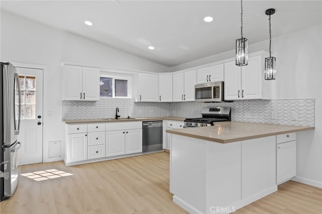 3516 Illinois Trl, Frazier Park, CA 93225 - kitchen featuring lofted ceiling, backsplash, light wood-style flooring, and appliances with stainless steel finishes