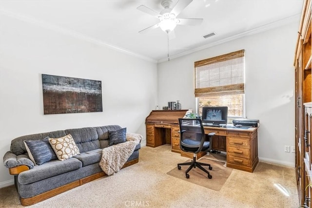 office space featuring light colored carpet, crown molding, visible vents, and a ceiling fan